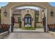 Grand estate entry with ornate gates and fountain feature at 11179 E Honda Bow Rd, Scottsdale, AZ 85262