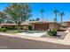 Single-story home with a two-car garage and landscaped yard at 12620 W Parkwood Dr, Sun City West, AZ 85375