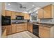 Well-equipped kitchen with light wood cabinets and granite counters at 12620 W Parkwood Dr, Sun City West, AZ 85375