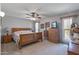Main bedroom with wooden furniture and ceiling fan at 12620 W Parkwood Dr, Sun City West, AZ 85375