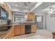 Modern kitchen with light wood cabinets and black appliances at 12620 W Parkwood Dr, Sun City West, AZ 85375
