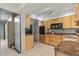 Open kitchen with light wood cabinets and black appliances at 12620 W Parkwood Dr, Sun City West, AZ 85375