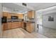 Modern kitchen with light wood cabinets and black appliances at 12620 W Parkwood Dr, Sun City West, AZ 85375