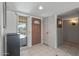 Light and airy entryway with tile floor and wood door at 12620 W Parkwood Dr, Sun City West, AZ 85375