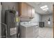Laundry room with washer, dryer and storage cabinets at 12620 W Parkwood Dr, Sun City West, AZ 85375