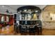 Circular wet bar with mirrored accents and black granite countertop at 5400 E Valle Vista Rd # 6, Phoenix, AZ 85018