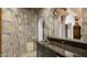 Basement bar with granite countertop and stone feature wall at 5400 E Valle Vista Rd # 6, Phoenix, AZ 85018