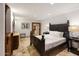 Spacious bedroom with a dark wood bed frame and ensuite bathroom access at 5400 E Valle Vista Rd # 6, Phoenix, AZ 85018