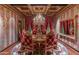 Opulent dining room with rich colors, ornate furniture, and a chandelier at 8353 N 58Th Pl, Paradise Valley, AZ 85253