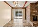 Bright dining room with brick fireplace and sliding glass doors at 8413 E Jackrabbit Rd, Scottsdale, AZ 85250