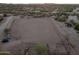 Large fenced riding arena with surrounding landscape at 1910 W Roderick Ln, Wickenburg, AZ 85390