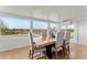 Sun-drenched dining area with large windows and a wooden table at 1910 W Roderick Ln, Wickenburg, AZ 85390