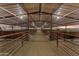 Spacious barn with multiple stalls and a dirt floor at 1910 W Roderick Ln, Wickenburg, AZ 85390