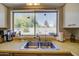 Kitchen sink with a view of the backyard through a large window at 4804 W Desert Cove Ave, Glendale, AZ 85304