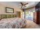 Bedroom with a floral bedspread and sliding glass doors to the pool at 806 W Oregon Ave, Phoenix, AZ 85013