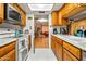 Updated kitchen with wood cabinets and view into living room at 5534 W Tierra Buena Ln, Glendale, AZ 85306
