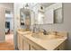 Double vanity bathroom with a large mirror and view into the home at 5534 W Tierra Buena Ln, Glendale, AZ 85306