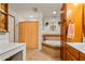 Bathroom with corner bathtub and double sink vanity at 5534 W Tierra Buena Ln, Glendale, AZ 85306