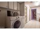 A laundry room with a washer, dryer, and cabinets at 5534 W Tierra Buena Ln, Glendale, AZ 85306