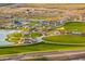 Aerial view of a community park with a lake, playground, and sports fields at 4815 S 119Th Dr, Avondale, AZ 85323