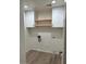 Bright laundry room with built-in shelving and modern flooring at 15270 W Taylor St, Goodyear, AZ 85338