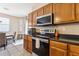 Well-equipped kitchen featuring stainless steel appliances and wood cabinets at 46057 W Dutchman Dr, Maricopa, AZ 85139