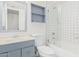 Bathroom with blue vanity, shower/tub, and tiled walls at 6730 W Monterosa St, Phoenix, AZ 85033