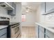 Open kitchen with gray cabinets and tile flooring at 6730 W Monterosa St, Phoenix, AZ 85033