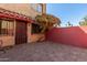 Private patio with brick pavers and a red door at 6730 W Monterosa St, Phoenix, AZ 85033