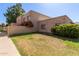 Tan stucco exterior with landscaping and grassy area at 6730 W Monterosa St, Phoenix, AZ 85033