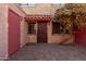 Private patio with brick pavers and a red door at 6730 W Monterosa St, Phoenix, AZ 85033
