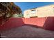 Small patio area with red brick walls and gate at 6730 W Monterosa St, Phoenix, AZ 85033