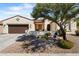 Single-story home with brown garage door and desert landscaping at 16 N Agua Fria Ln, Casa Grande, AZ 85194