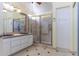 Elegant bathroom featuring double sinks, a shower, and a tiled floor at 126 S Lucia Ln, Casa Grande, AZ 85194