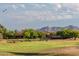 Golf course view with mountains in the distance at 126 S Lucia Ln, Casa Grande, AZ 85194