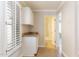 Laundry room with cabinets and access to a nearby bathroom at 126 S Lucia Ln, Casa Grande, AZ 85194
