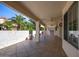 Covered patio with tiled flooring, ceiling fan, and lush landscaping at 126 S Lucia Ln, Casa Grande, AZ 85194