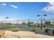 Well-maintained tennis court with surrounding fence at 126 S Lucia Ln, Casa Grande, AZ 85194