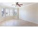 Living room featuring bay windows and a ceiling fan at 126 S Lucia Ln, Casa Grande, AZ 85194
