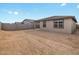 Backyard view of house and empty lot at 16074 W Cottontail Ln, Surprise, AZ 85387