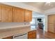 Kitchen with light wood cabinets, dishwasher, and view into living room at 2308 N Gayridge Rd, Mesa, AZ 85215