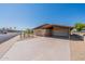 Mid-century modern home with carport and nicely landscaped yard at 2308 N Gayridge Rd, Mesa, AZ 85215