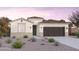 One-story home with desert landscaping and dark garage door at 10211 S Bickwell Trl, Apache Junction, AZ 85120