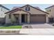 Front view of charming house with two-car garage and landscaping at 24173 N 160Th Ave, Surprise, AZ 85387