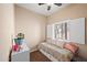 Bright bedroom with a daybed, window shutters, and a plant at 913 S Apache Dream Way, Apache Junction, AZ 85120