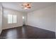 Bright bedroom featuring dark laminate flooring and a ceiling fan at 9065 E Gary Rd # 147, Scottsdale, AZ 85260