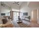 Bright living room featuring a cozy fireplace and sliding glass doors leading to a patio at 9065 E Gary Rd # 147, Scottsdale, AZ 85260