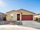 Tan house with red garage door and stone accents at 17455 W Sanna St, Waddell, AZ 85355