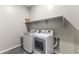 Laundry room with washer, dryer, and additional shelving at 2229 N Beverly Pl, Buckeye, AZ 85396