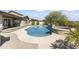 Inviting backyard oasis featuring a sparkling pool, spa, and built-in BBQ at 2229 N Beverly Pl, Buckeye, AZ 85396